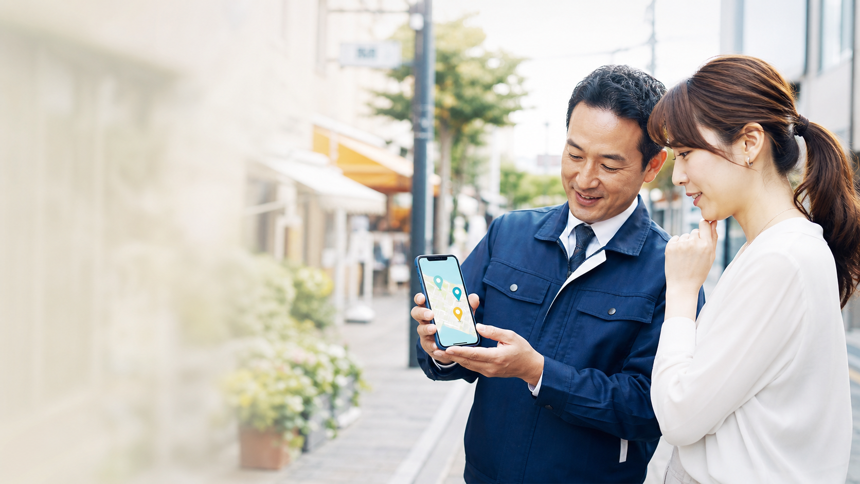 地域のサービス事業者がスマートフォンの対応エリアを顧客へ案内する様子